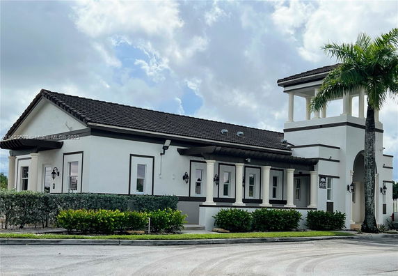 Front view of a building with columns and a tower feature.
