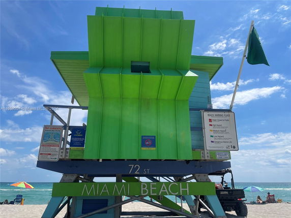 Front view of a lifeguard tower on Miami Beach with bright green and blue colors.