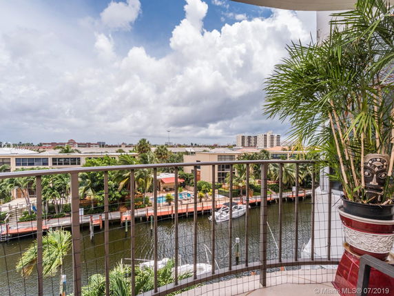 View from a balcony overlooking a canal and surrounding buildings.