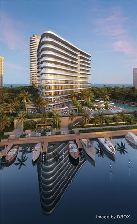 Front view of a modern multi-story building with curved balconies overlooking a waterfront.