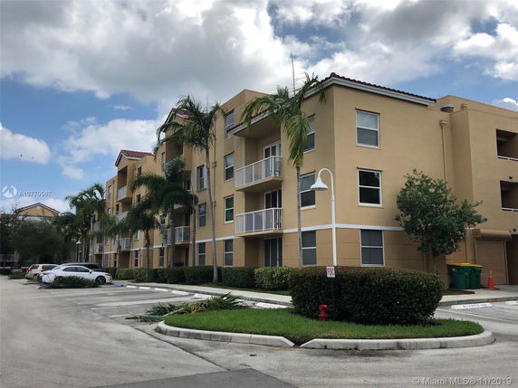 Front view of a multi-story residential building with balconies.