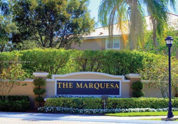 Front view of a residential building with a prominent sign reading 'The Marquesa'.