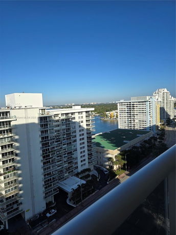 Panoramic view of high-rise buildings with a body of water in the background.