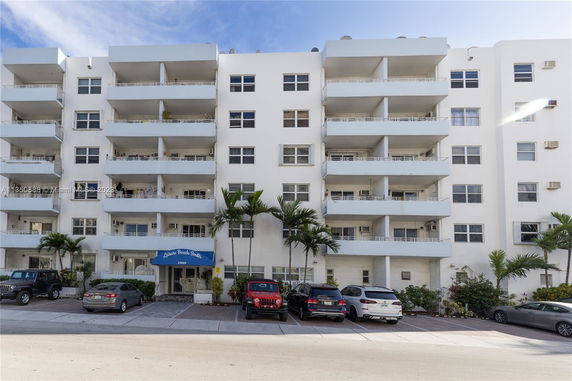Front view of a multi-story building with balconies.