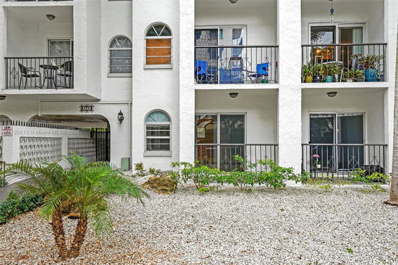 Front view of a multi-story residential building with balconies.