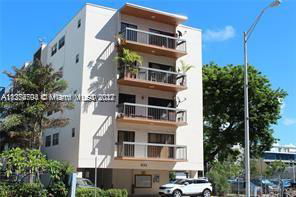 Front view of a multi-story apartment building with balconies.