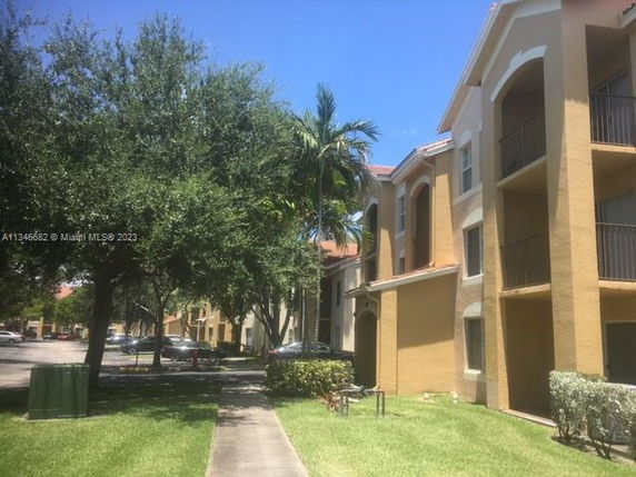 Front view of a multi-story residential building with balconies.