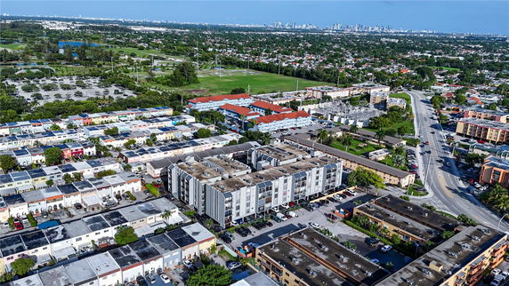 Aerial view of a residential area with various buildings and streets.