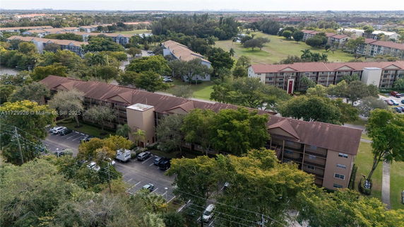 Aerial view of multiple residential buildings with surrounding greenery.