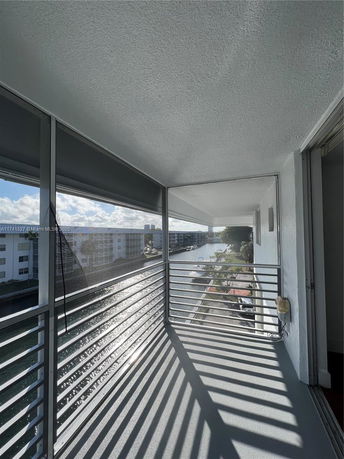 Balcony view overlooking water and adjacent buildings.