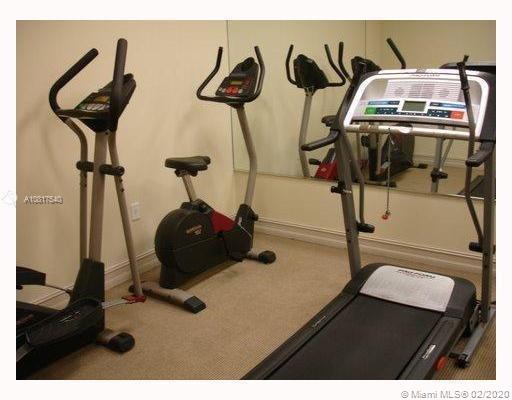 Indoor gym with exercise bikes and a treadmill.