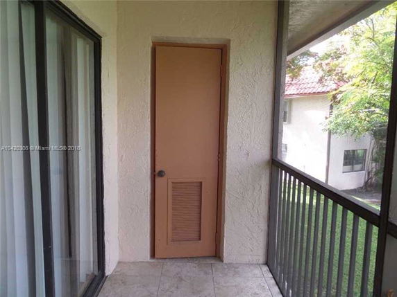 Balcony area with a partial view of an exterior building wall and windows.