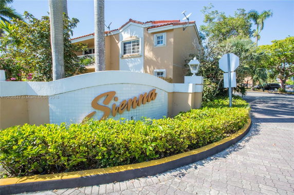 Front view of a two-story building with a sign reading 'Sienna'.