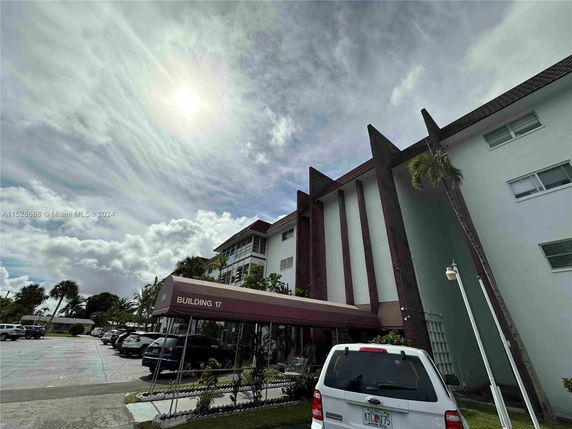 Front view of a multi-story building with distinctive vertical architectural elements.