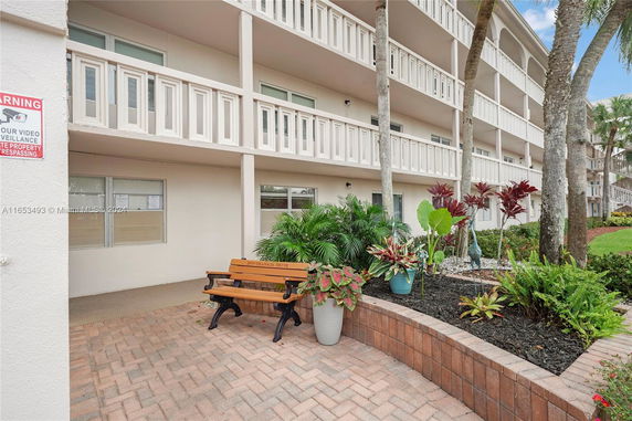Front view of a multi-story residential building with balconies.