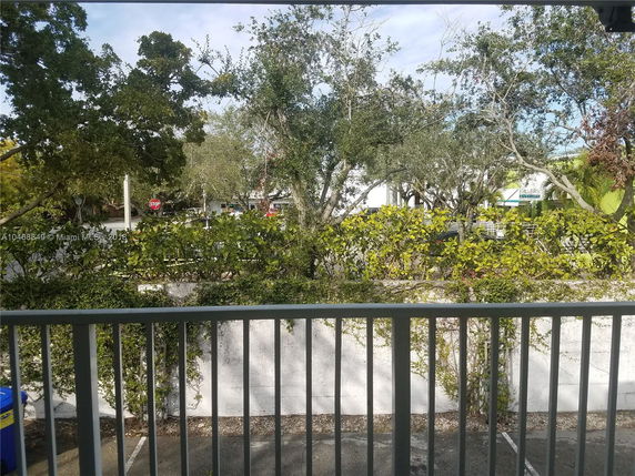 View of trees and surrounding area from a balcony