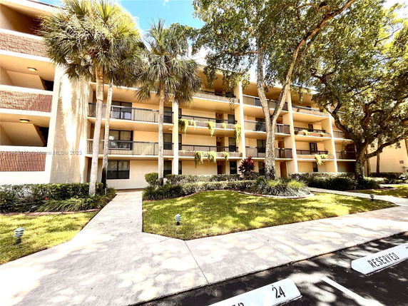 Front view of a multi-story apartment building with balconies.