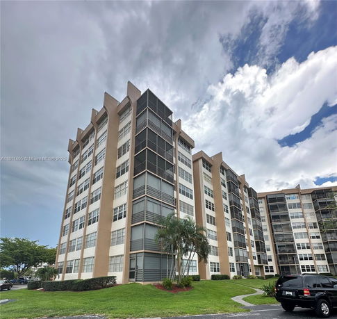 Front view of a multi-story residential building with screened balconies.