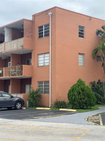 Front view of an apartment building with multiple balconies.