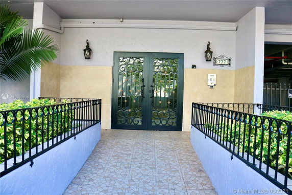 Front entrance of a building with decorative double doors.