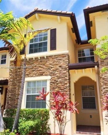 Front view of a two-story house with stone facade accents.