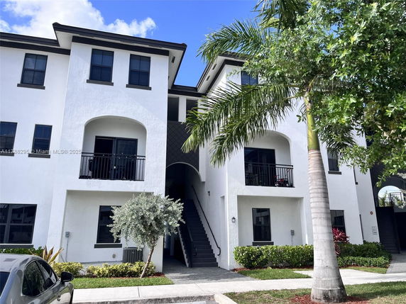 Front view of a multi-story residential building with balconies.