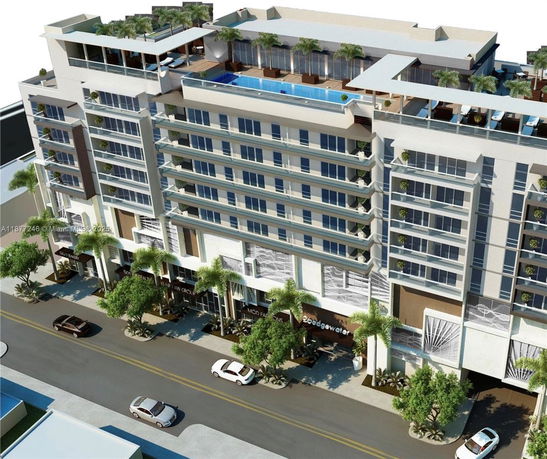 Front view of a multi-story building with a rooftop pool and terraces.