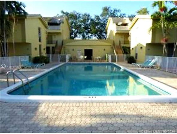 Outdoor swimming pool area with adjacent buildings