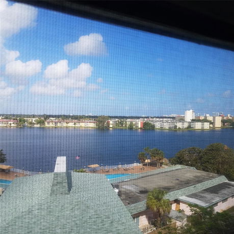 View of a lake with buildings in the distance, seen from above.