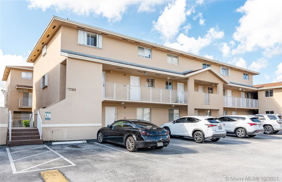 Front view of a multi-story residential building with balconies.