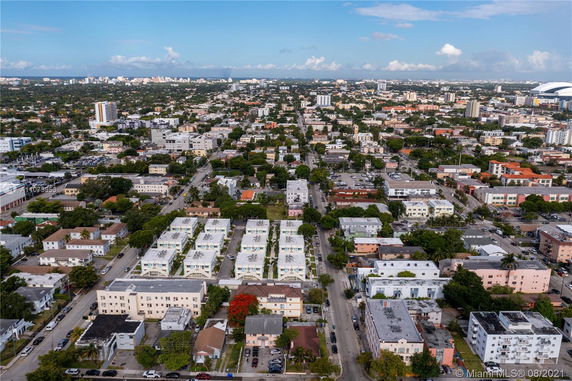 Aerial view of a cityscape with numerous buildings and roads extending towards the horizon.