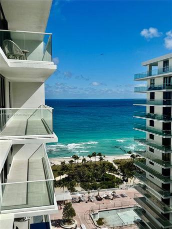 Panoramic view of balconies overlooking a beach and ocean.