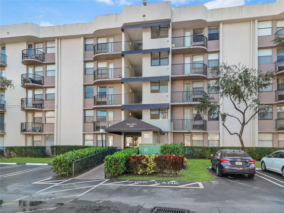 Front view of a multi-story residential building with balconies.