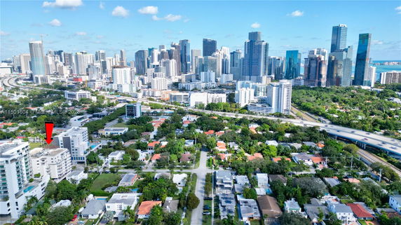 Aerial view of urban area with skyscrapers and residential buildings.