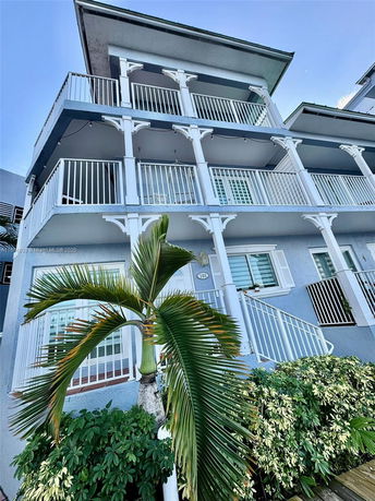 Front view of a multi-story building with balconies.