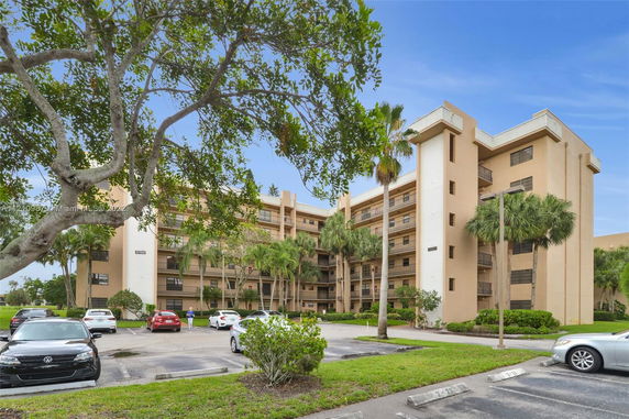 Front view of a multi-story apartment building with balconies.