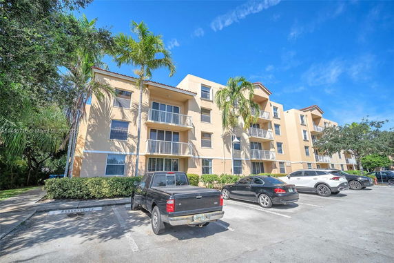 Front view of a multi-story apartment building with balconies.