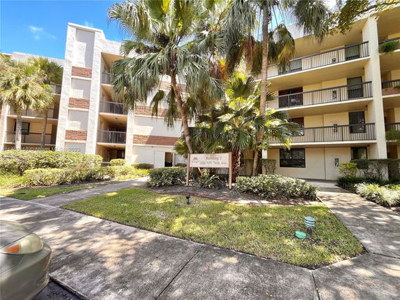 Front view of a multi-story apartment building with balconies.
