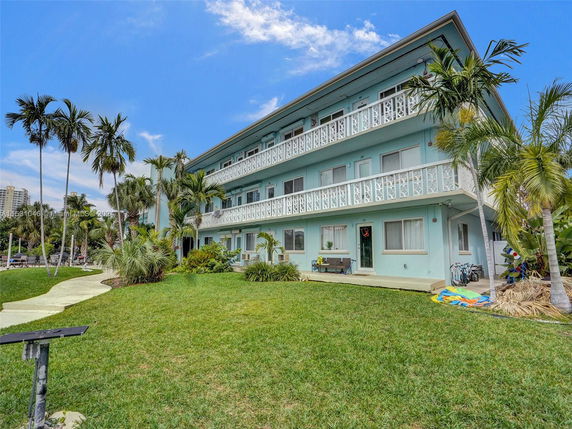 Front view of a multi-story residential building with balconies.