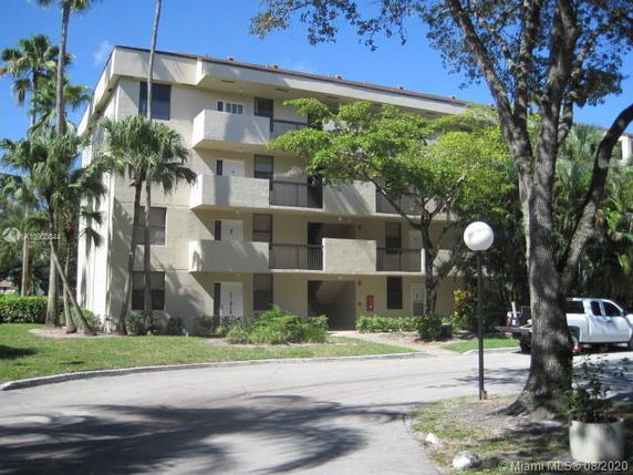 Front view of a multi-story residential building with balconies.