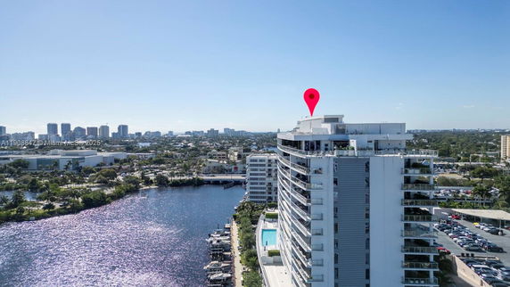 Panoramic view of a high-rise building overlooking a waterfront and cityscape.