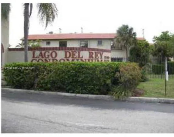 Front view of a condominium building with a sign reading 'Lago Del Rey Condominiums'.