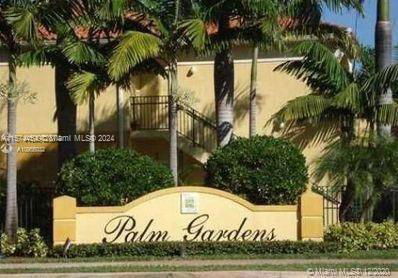 Front view of a building labeled Palm Gardens with palm trees.