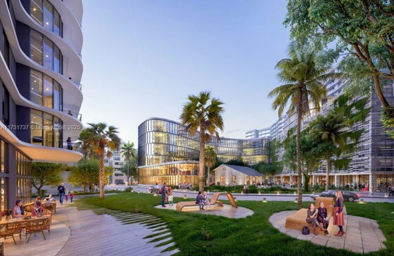 View of modern buildings with glass facades and surrounding green spaces.