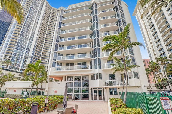 Front view of a multi-story residential building with balconies.