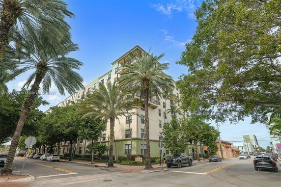 Front view of a multi-story apartment building with balconies.