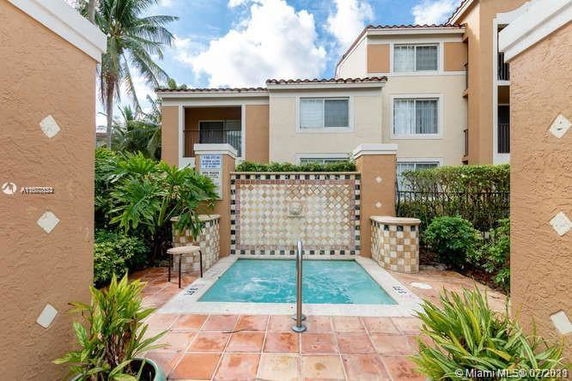 Small outdoor pool area with surrounding building view