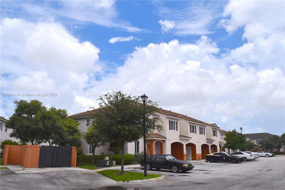 Front view of a two-story residential building with garages.