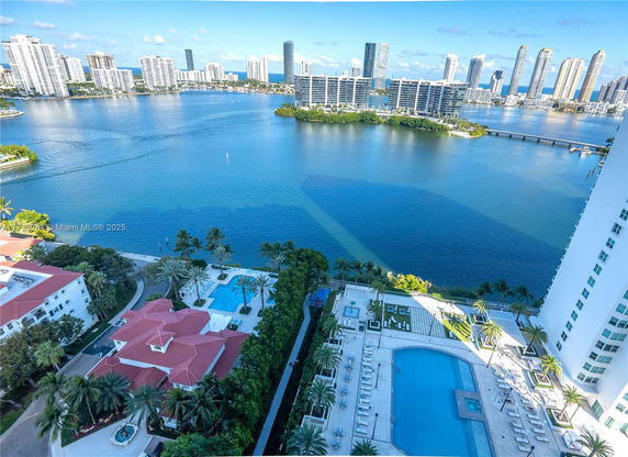 Panoramic view from a high-rise building overlooking a large body of water and surrounding cityscape.