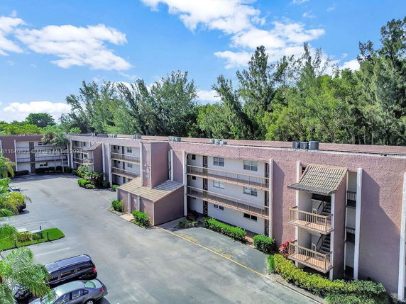 Front view of a multi-story residential building with balconies.